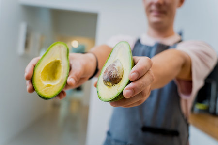 Chef at the kitchen preparing healthy quinoa bowl with avocado