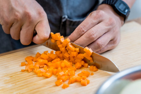Chef at the kitchen preparing healthy quinoa bowl with avocado