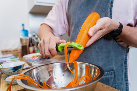 Chef at the kitchen preparing massaman curry with sweet potato and many spicesの写真素材