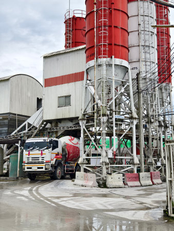 A concrete mixer truck is stationary outside of a concrete factoryの写真素材
