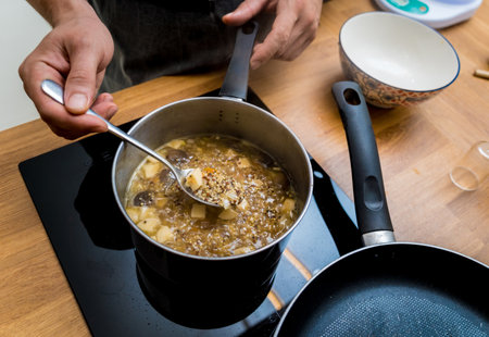 Chef at the kitchen preparing healthy quinoa bowl with avocadoの写真素材