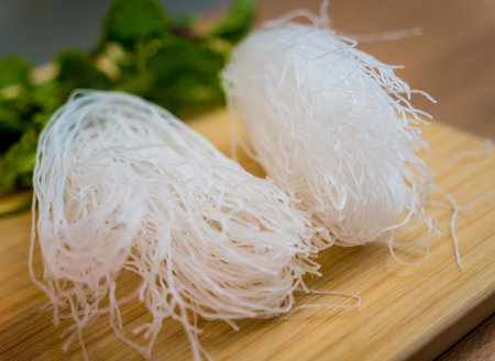 Cutting board with ingredients for preparing spicy glass noodle saladの写真素材