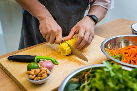 Chef at the kitchen preparing spicy glass noodle saladの写真素材