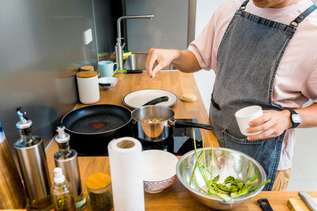 Chef at the kitchen preparing healthy quinoa bowl with avocado