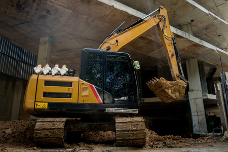A significant pile of ground is being excavated by a bulldozer