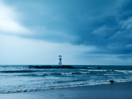 A solitary lighthouse stands in the oceanの写真素材