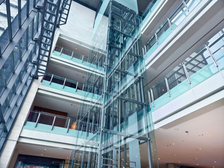 A modern tall building that features a significant amount of glassの写真素材