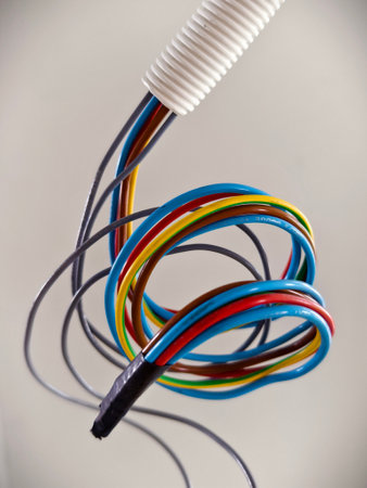 A collection of various wires is hanging down from the ceilingの写真素材