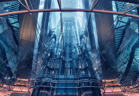 A modern tall building that features a significant amount of glassの写真素材