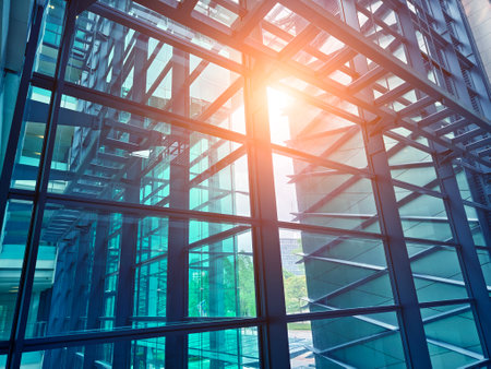 A modern tall building that features a significant amount of glassの写真素材