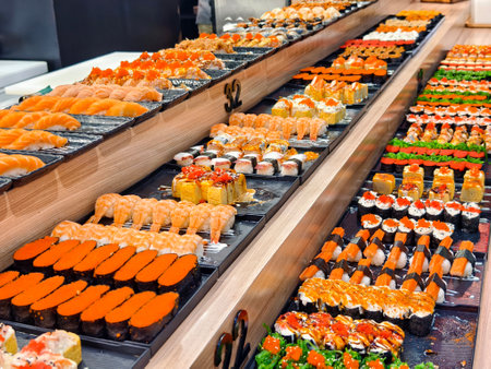 Delicious sushi rolls are beautifully arranged on platesの写真素材