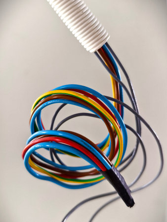 A collection of various wires is hanging down from the ceiling