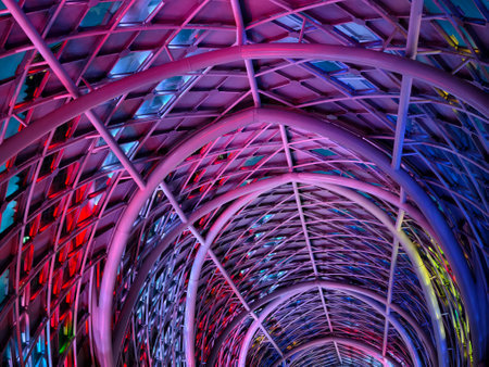 A stunning tunnel with vibrant purple and blue ceiling lightsの写真素材
