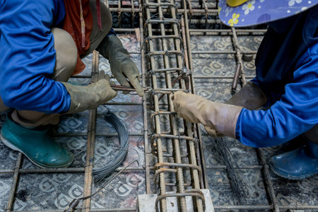 A group of builders is busy constructing a metal structure