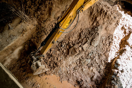 A significant pile of ground is being excavated by a bulldozer