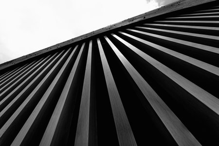 A structure featuring wooden slats on construction site contributing to its architectural styleの写真素材