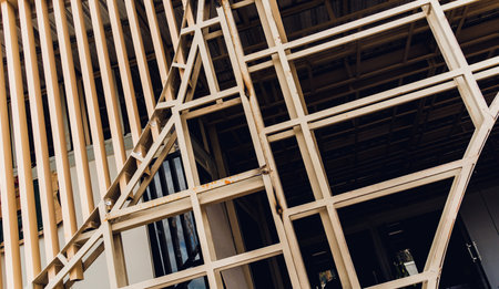 A structure featuring wooden slats on construction site contributing to its architectural styleの写真素材