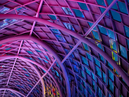 A stunning tunnel with vibrant purple and blue ceiling lightsの写真素材