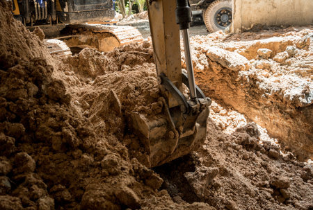 A significant pile of ground is being excavated by a bulldozer