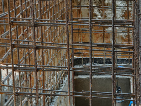 A construction site displaying a reinforced concrete foundation with steel rebarの写真素材