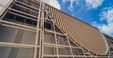A structure featuring wooden slats on construction site contributing to its architectural style