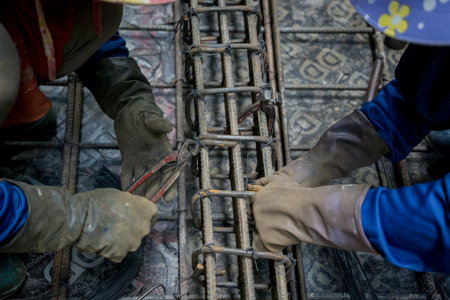 A group of builders is busy constructing a metal structureの写真素材