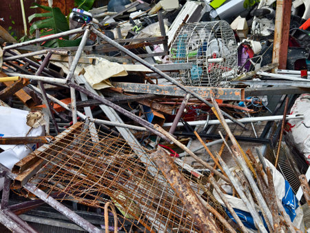 A pile of garbage with a bucket, rope, bottles, and other items at a landfillの写真素材