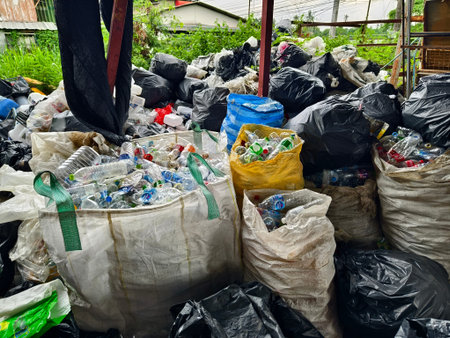 There is a large pile of plastic bottles and cans stored inside a bag