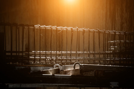 A construction site displaying a reinforced concrete foundation with steel rebarの写真素材