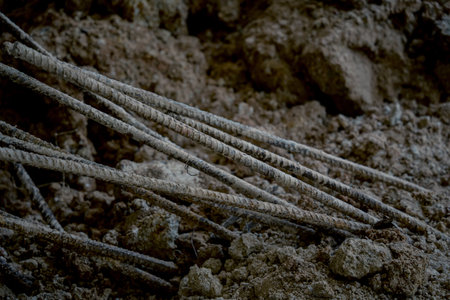 Large pile of earth in which there are many metal reinforcement barsの写真素材