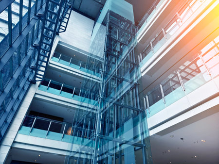 A modern tall building that features a significant amount of glassの写真素材