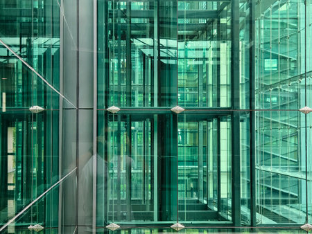 A modern tall building that features a significant amount of glassの写真素材