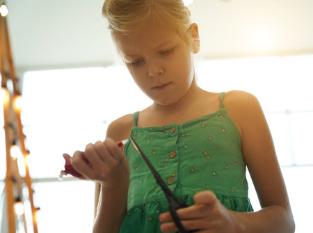 Mother and her daughter paint cookiesの写真素材