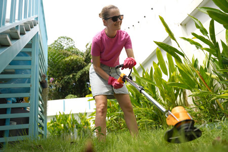 A young woman trims her beautiful gardenの写真素材