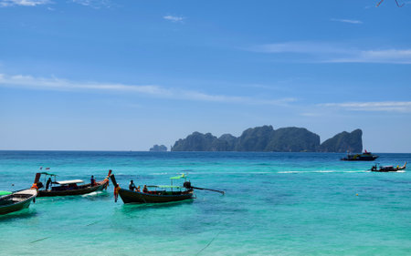 A serene and beautiful tropical beach paradise featuring traditional boatsの写真素材