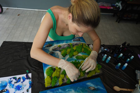 The process of making the art decor of epoxy resin, natural stones and moss