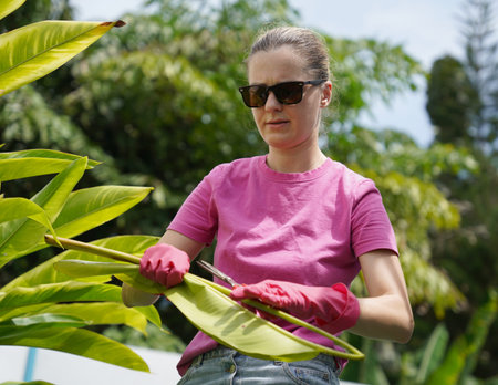 A young woman trims her beautiful garden