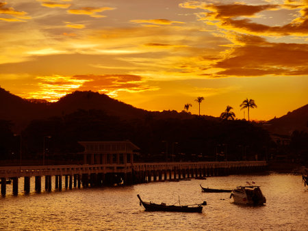 A beautifully serene view of a stunning sunset with fishing boatsの写真素材