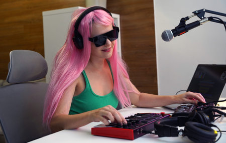 Beautiful young singer and musician broadcast from her home studioの写真素材