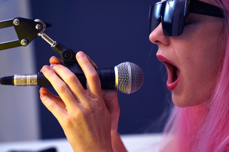 Beautiful young singer and musician broadcast from her home studioの写真素材