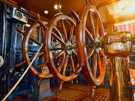A row of wooden steering wheels located on an old vesselの写真素材