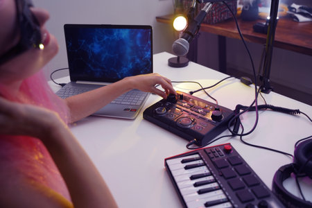 Beautiful young singer and musician broadcast from her home studioの写真素材