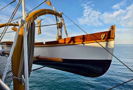 A lifeboat is securely tied to the mast of a sailing vessel