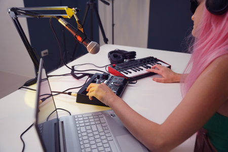 Beautiful young singer and musician broadcast from her home studioの写真素材