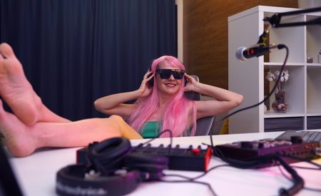 Beautiful young singer and musician broadcast from her home studioの写真素材