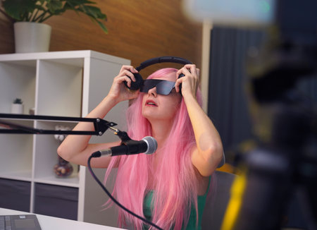 Beautiful young singer and musician broadcast from her home studioの写真素材