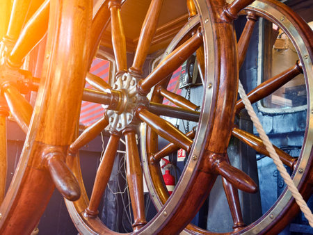 A row of wooden steering wheels located on an old vesselの写真素材
