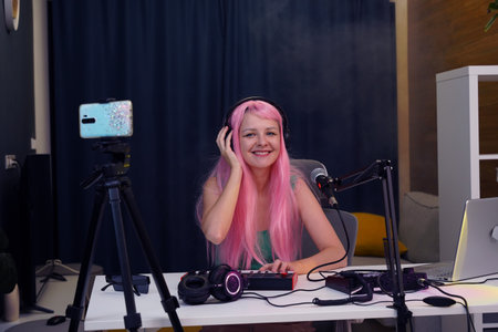 Beautiful young singer and musician broadcast from her home studioの写真素材