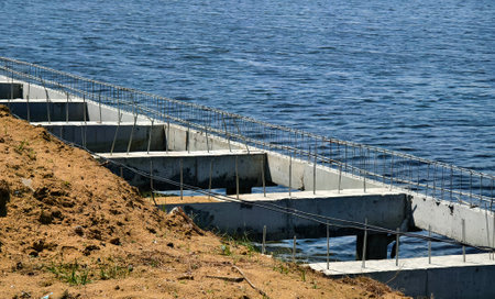 Construction of a modern pedestrian embankment on a large lakeの写真素材