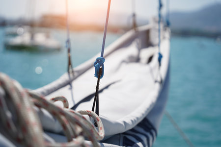 A white voyage boat featuring a steering wheel floating in the waterの写真素材